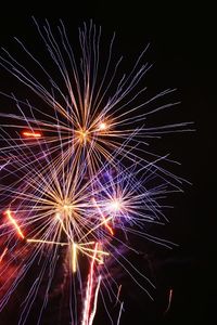 Low angle view of firework display at night