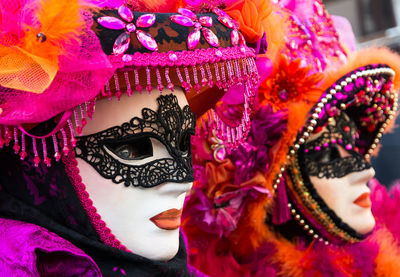 Woman wearing mask and headdress