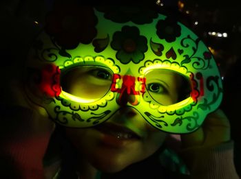 Close-up portrait of girl wearing illuminated eyewear