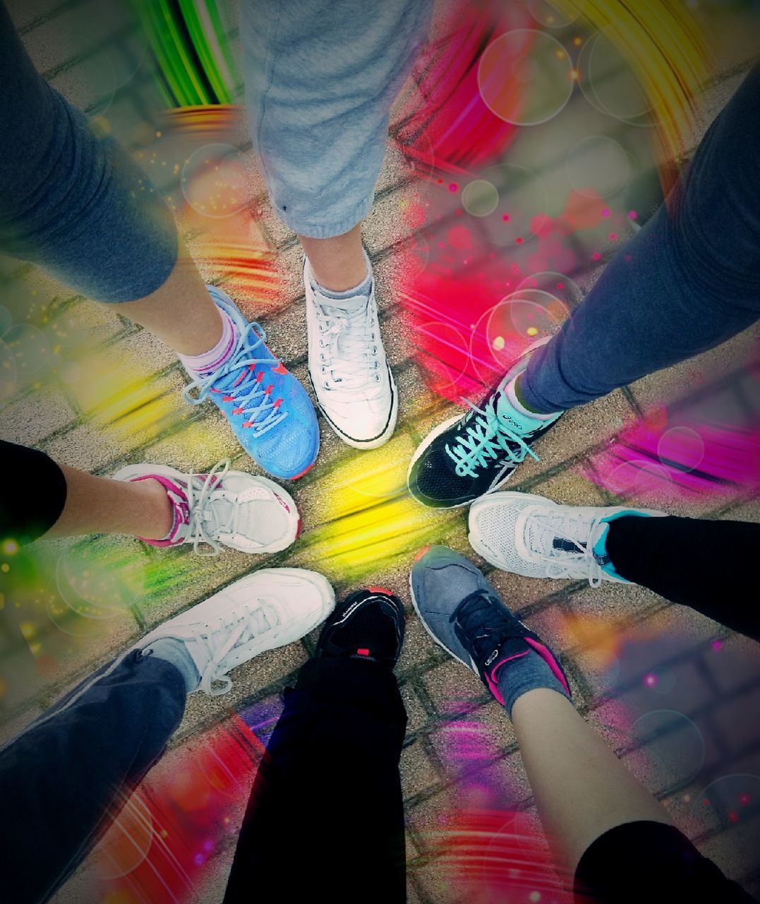 LOW SECTION OF WOMAN STANDING ON MULTI COLORED SHOES