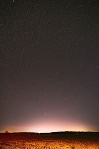 Scenic view of landscape against sky at night