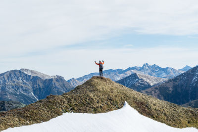 Man standing on mountain against sky