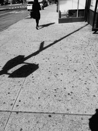 Shadow of woman on road
