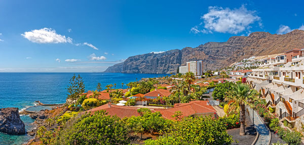 Panoramic view of townscape by sea against sky