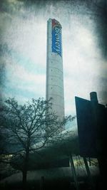 Low angle view of tower against cloudy sky