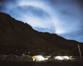 Scenic view of mountains against sky at night