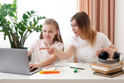 Mother helping daughter with homework