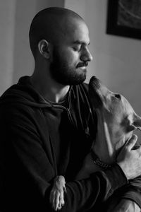 Close-up portrait of a man playing with a dog