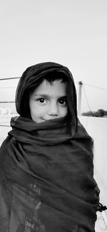 Portrait of girl standing against wall