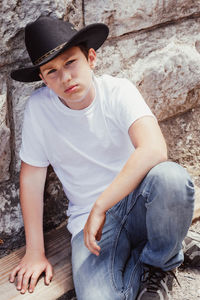 Portrait of man sitting in hat