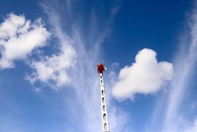 Low angle view of communications tower against blue sky