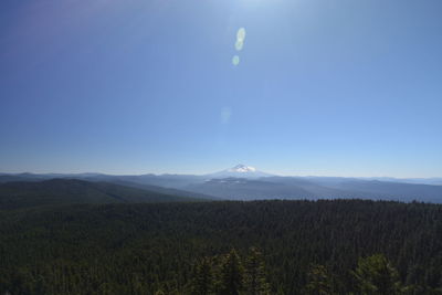 Scenic view of landscape against blue sky