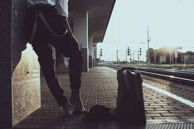 Low section of person waiting on railroad station platform