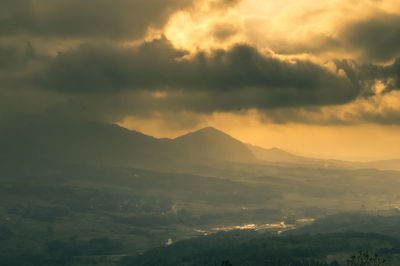 Scenic view of mountains against sky at sunset