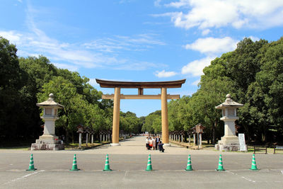 Built structure by trees against sky