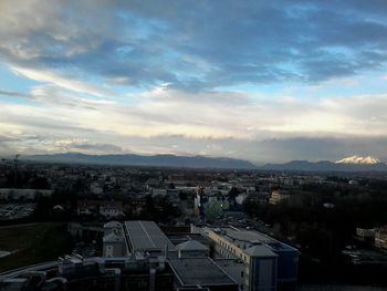 Cityscape against cloudy sky