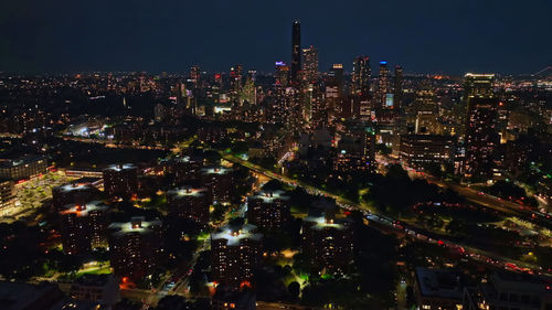 High angle view of illuminated buildings in city at night