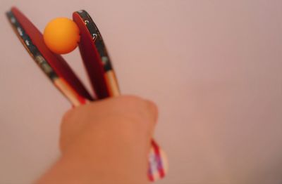 Close-up of hand holding table tennis racket