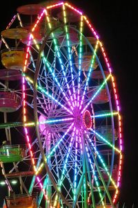 Low angle view of ferris wheel at night