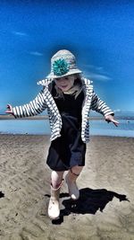 Full length of girl playing on beach