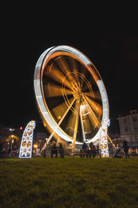 3.12. 2022 - ostrava, czech republic. view of a spinning ferris wheel glowing yellow-white
