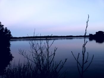 Scenic view of lake against sky at sunset