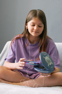 Smiling girl listening music at home