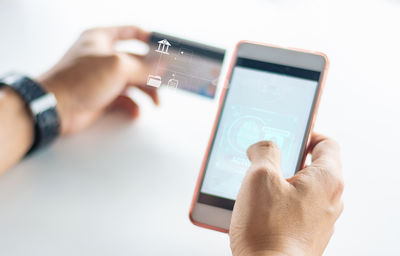 Cropped hand using mobile phone