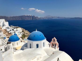 High angle view of sea and buildings against sky