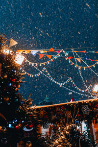 Christmas tree and flying snow in the evening light in festive magic new year