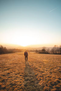 Man in shirt watching sunset. soaking up positive energy and relieving stress