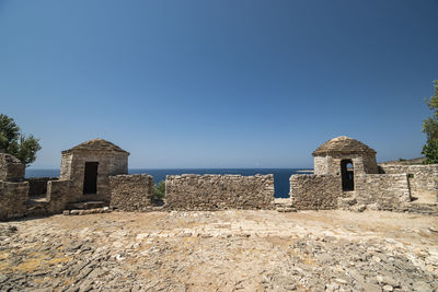 Old ruin building against clear blue sky