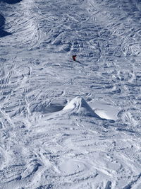 High angle view of person skiing downhill on snow