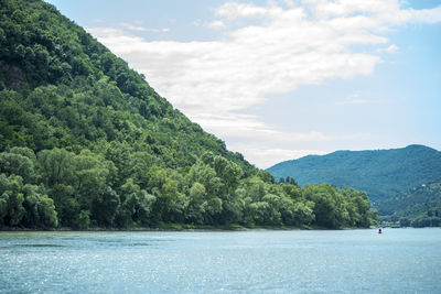 Scenic view of sea and mountains against sky