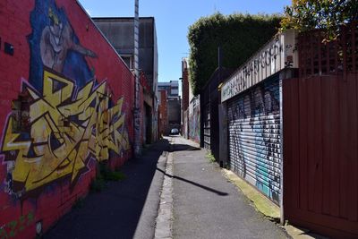 Graffiti on footpath amidst buildings in city