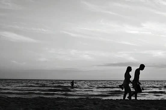 MAN ON BEACH AGAINST SKY