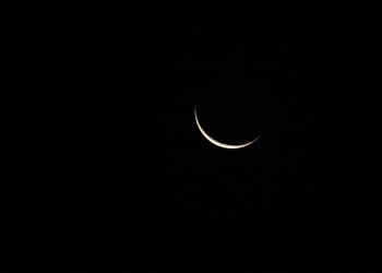 Low angle view of moon in sky at night