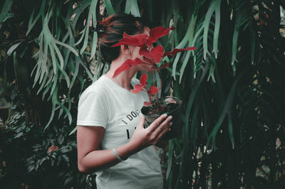 Woman holding butterfly on flower