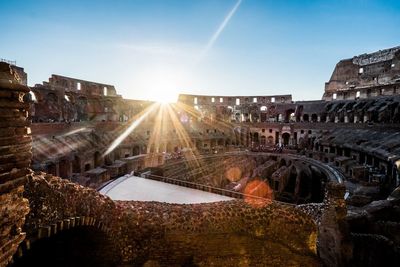 Coliseum against clear blue sky on sunny day