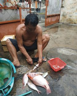 High angle view of man holding fish