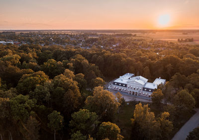 High angle view of trees and buildings against sky during sunset