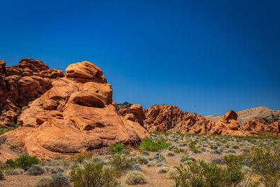 Rock formations against clear blue sky