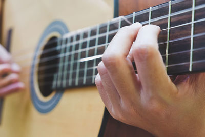 Cropped image of man playing guitar