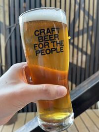 Close-up of hand holding beer glass