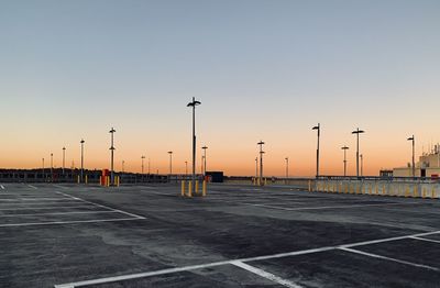 Street lights against sky during sunset