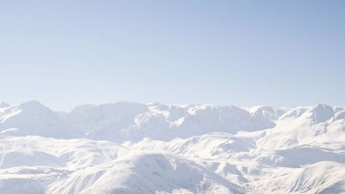 Scenic view of snow mountains against clear sky