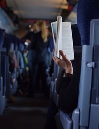 Woman reading book in train