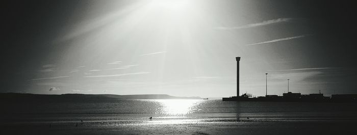 Scenic view of silhouette beach against sky