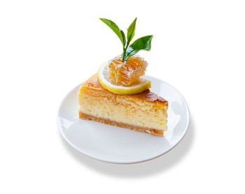 Close-up of cake on plate against white background