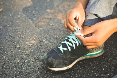 Low section of man wearing shoes